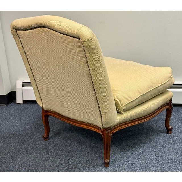 Elegant Ralph Lauren accent chair with classic French-inspired styling. The warm brown wood frame features intricate...