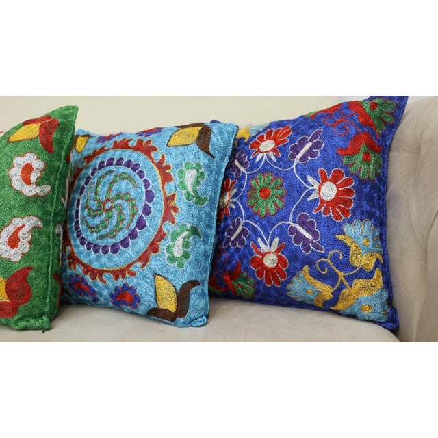 Infuse your home with the rich heritage of Central Asia with this exquisite Hand-Embroidered Suzani Cushion Cover, crafted...