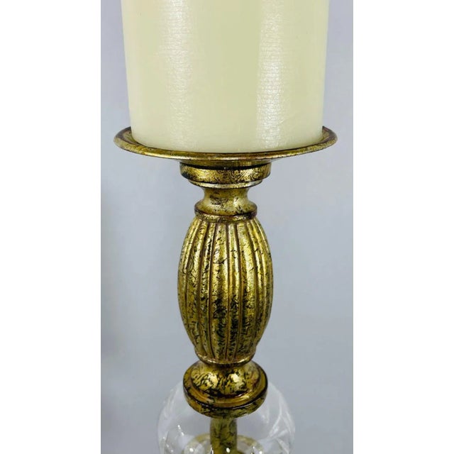 A pair of Italian Rococo style tall candle holders. The Rococo candle holders are hand carved of gilt metal in an Vintage...