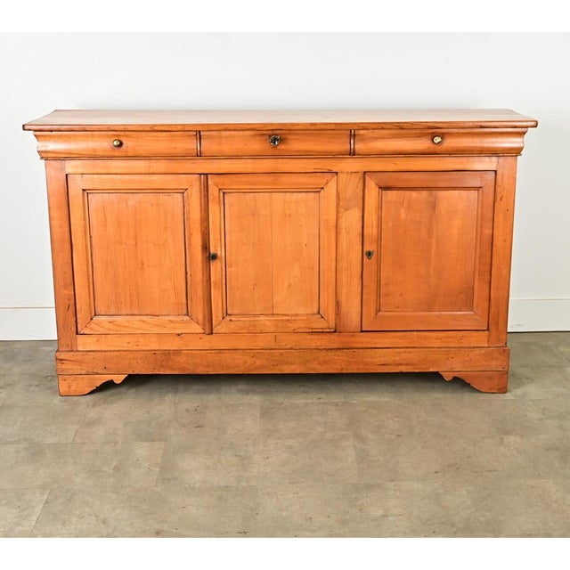 Dimensions: 39” H x 68 3/8” W x 19 ¾” D This beautiful, Louis Philippe fruitwood enfilade, circa 1840, is remarkable for...