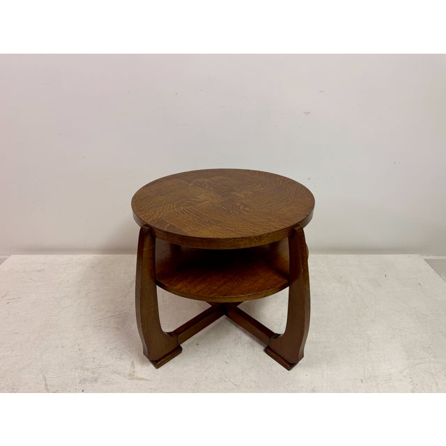 A Dutch oak coffee table in the manner of the Amsterdam School, dating from the early to mid-20th century. Executed in...