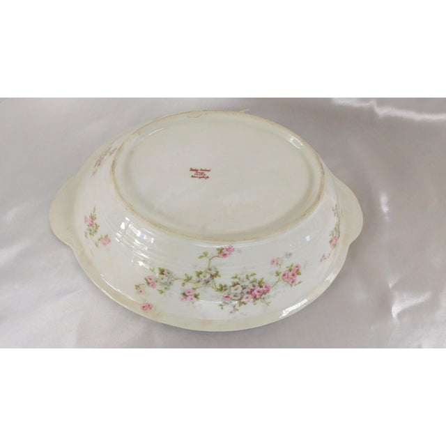 This is a Theodore Haviland oval vegetable bowl in an unknown pattern with pink ande white flowers and a beaded rim...