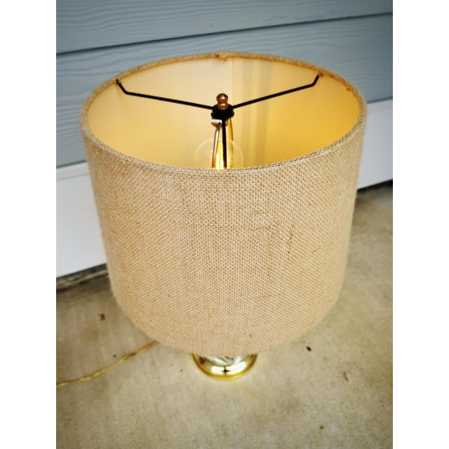 Charming vintage coastal table lamp featuring a beautifully shaped clear glass vessel filled with an abundant assortment...