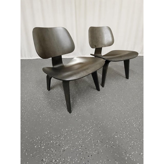 Charles Eames lounge chairs for Herman Miller, c. 2009. The design features a low seated bent plywood chair. It is...