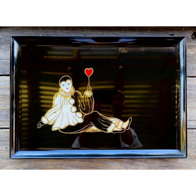 There is something quietly touching about this Couroc tray. Rather than portraying the playful circus clown so often...