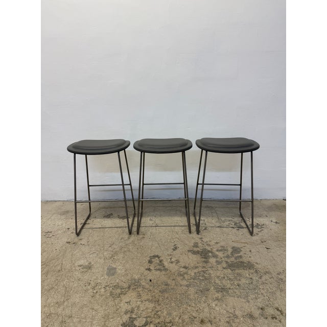 Set of Three Hi Pad counter stools with foot rests designed by Jasper Morrison for Cappellini. The Hi Pad stool features a...