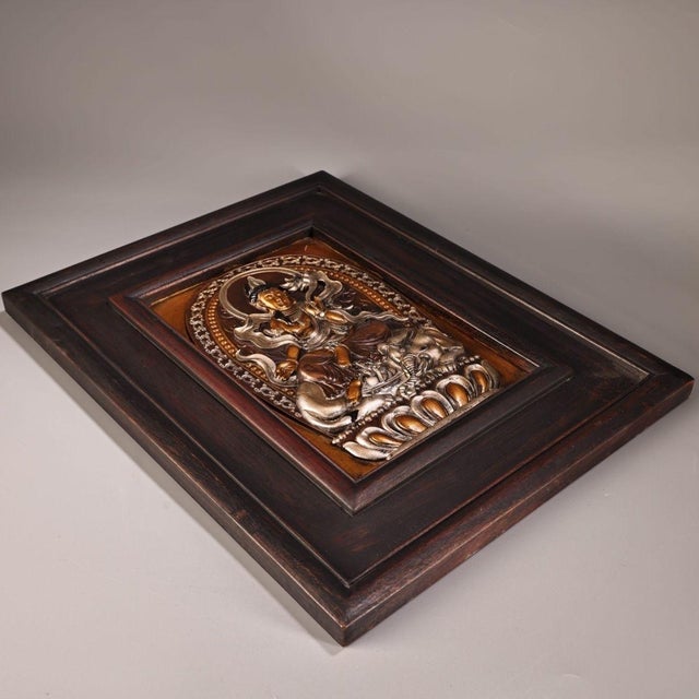 This is an exquisite antique repoussé copper plaque, presented within a solid, dark wooden frame. The piece depicts a...