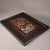 This is an exquisite antique repoussé copper plaque, presented within a solid, dark wooden frame. The piece depicts a...