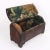 Small wooden travel box covered with iron lamina bands fixed through small studs. The metal bands are adorned with a...