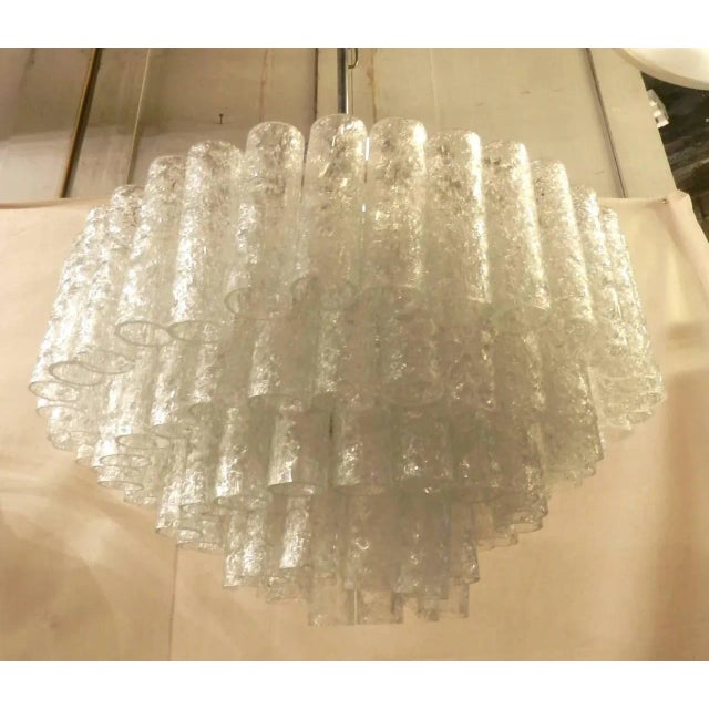 Elegant chandelier with beautiful array of cascading crackled glass pendants. Excellent lighting with sockets for up to...
