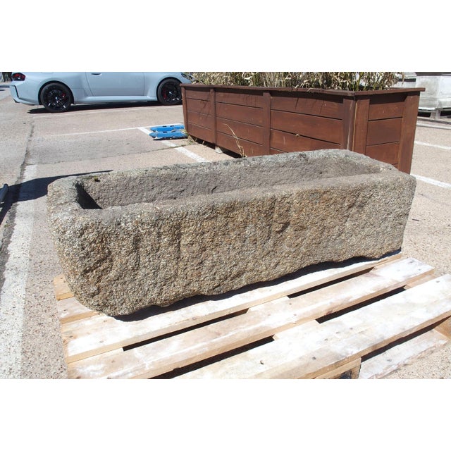 This large hand-carved granite farm trough was discovered on a property in Normandy, France. The gray stone has developed...