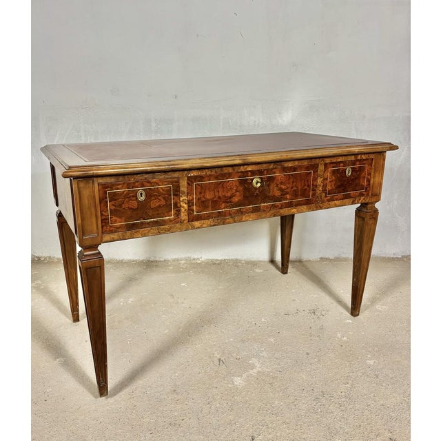 Elegant early 20th century walnut writing desk in the Louis XVI taste, featuring refined neoclassical lines and beautiful...
