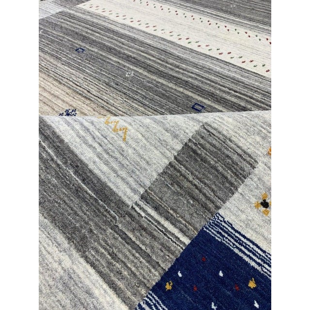 This hand knotted wool rug features a multicolor jewel tone palette and a consistent allover design. Produced in India,...