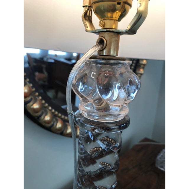 each of columnar form resting on a square base; originally fitted with a kerosene receptacle; height 20.5" (top of glass)...