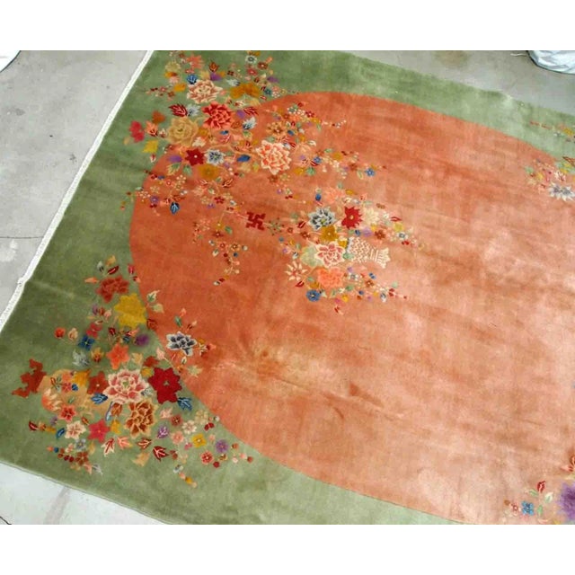 Handmade antique Art Deco Chinese rug in orange and green colours. The rug is from the end of 20th century in original...