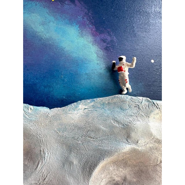 Galaxy art is a mixed media wall sculpture by vera vizzi that fuses astronomy-inspired painting with tactile lunar relief....