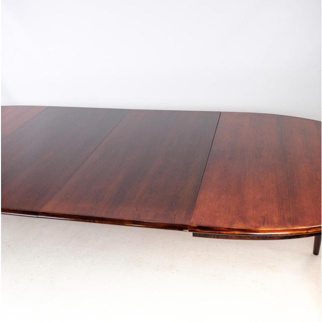 Oval dining table in rosewood, designed by arne vodder from around the 1960s. Measures: h:73, w:150/250, d:104.5 (two...