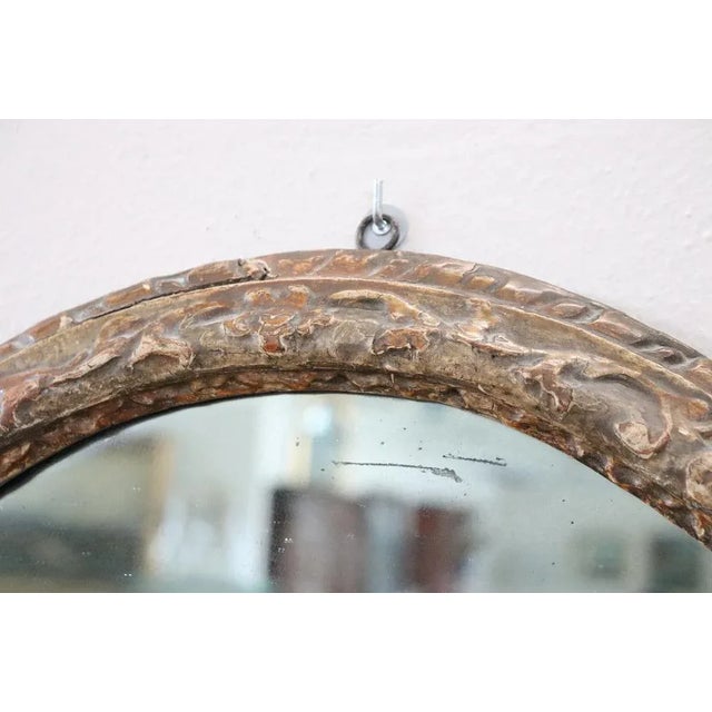 Beautiful elegant antique oval wall mirror. Italian Louis XIV 1680s. Hand carved wood with finely and richly swirls and...