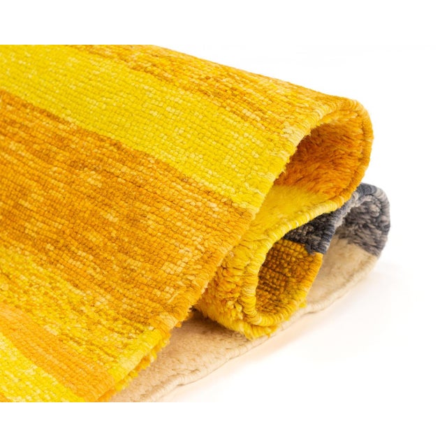 Vibrant hand-knotted wool rug featuring a striking blend of Mustard, Luminous Yellow, and shades of Grey, with an Ivory...