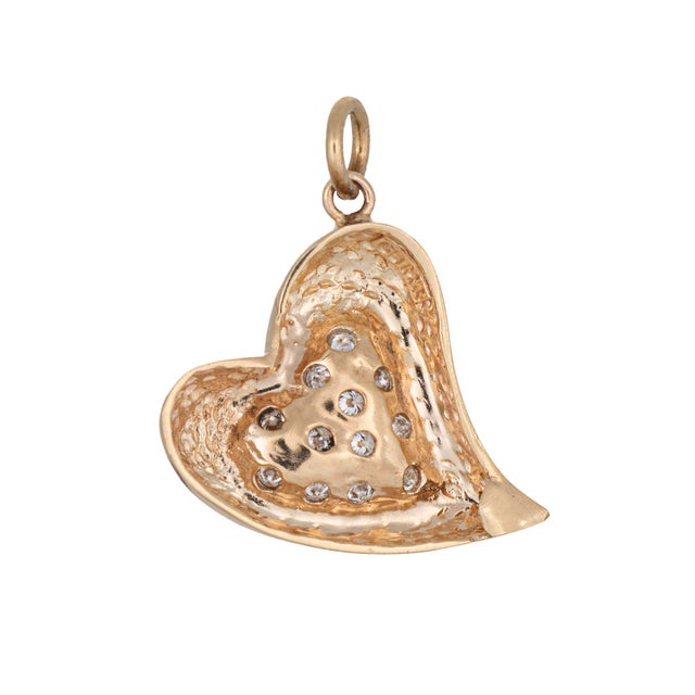 Finely detailed witch's heart diamond pendant crafted in 14k yellow gold. 12 diamonds total an estimated 0.12 carats...
