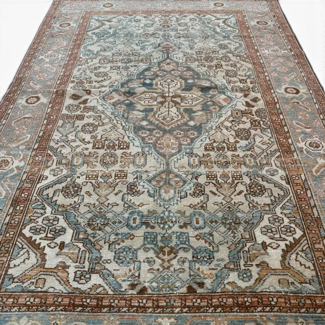 This elegant vintage Malayer rug showcases the refined artistry characteristic of Persian village weaving traditions. The...