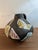Matte Black Ruscha vase with decorative white glaze and hand painted designs. Striking contrast in texture and color....