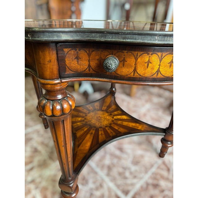Stunning Empire-style side table with walnut marquetry. The top features a marquetry design with a central motif...