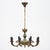 Chandelier from France in the Empire style. Made of painted bronze, this striking piece boasts eight “Cornupia” stylized...