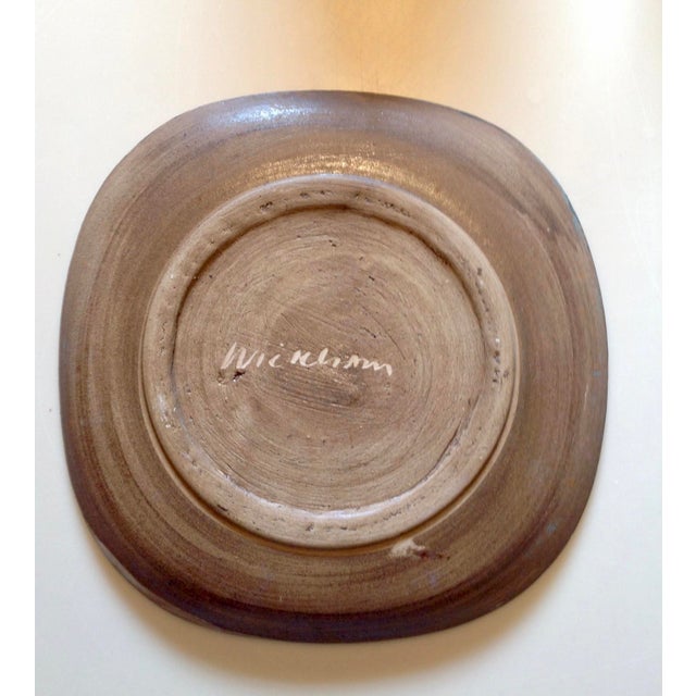 Mid-Century Modern signed decorative earthenware plate with primitive incised design by Nancy Wickham Boyd (1923-1987).