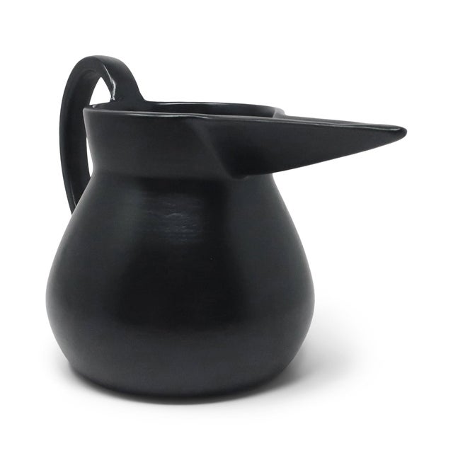 A squat jug in black bucchero ceramic designed by Gio Ponti, produced by Costantino for the Neoponti collection. The wide...