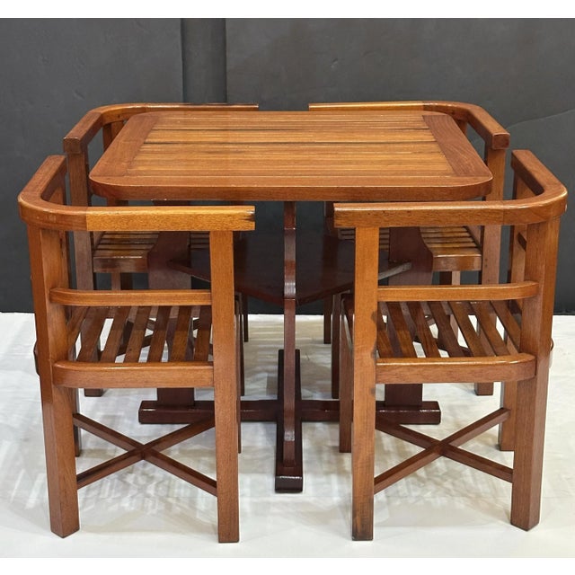 A handsome modular card or games table with four fitted chairs, circa 1930s - from the celebrated English design company,...