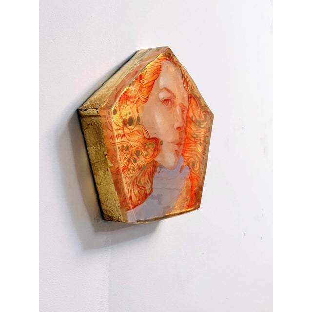 This hexagonal artwork features a striking portrait with flowing, vibrant hair that intertwines with intricate patterns,...
