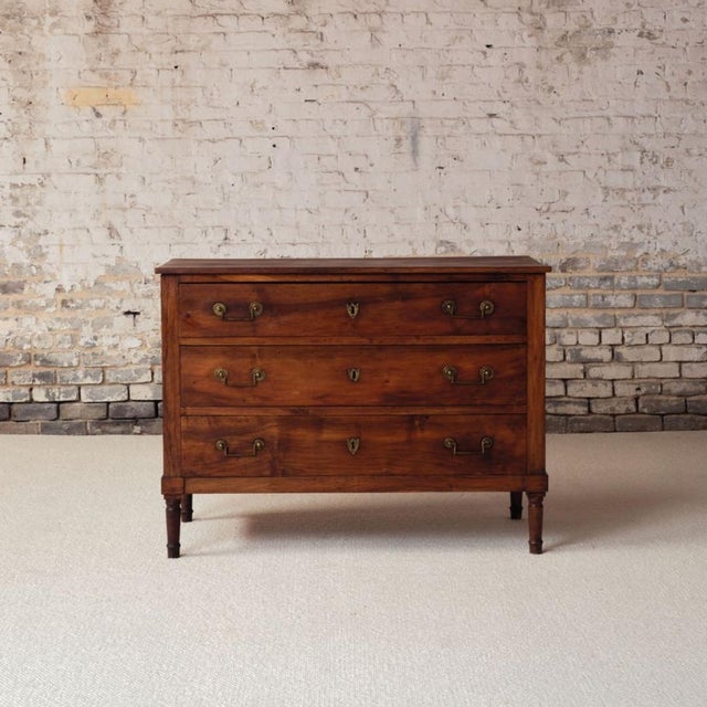 Elevate your space with the refined elegance of this 18th century French Louis XVI walnut chest of drawers, a beautifully...