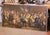 Large European historical painting depicting a lively banquet of officers and gentlemen gathered around a richly set...