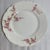 This is a vintage dinner plate set produced by Haviland & Company in Limoges, France, featuring a pink floral swag...