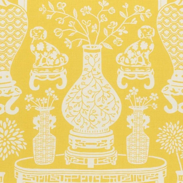 A preppy chinoiserie design features Ming vases and Staffordshire dogs in a pattern-on-pattern extravaganza with a...
