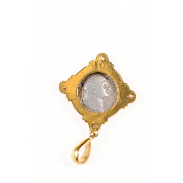 An authentic Roman Empire, Domitian (circa 81-96 AD), silver Denarius coin, minted in Rome, set in a custom 22k gold bezel...