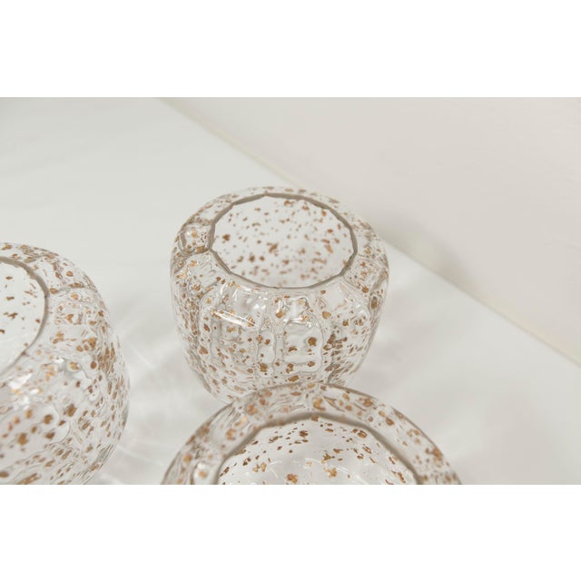 Chandelier from the 1960s with 5 branches. Solid star-shaped gold metal structure, with 5 blown glass sconces with...