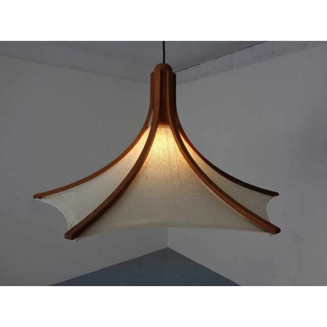 Adjustable teak ceiling lamp with counterweights by Domus. This piece has an attribution mark, I am sure that it is...