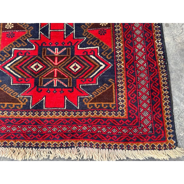 This Belouch Hand knotted wool Tribal rug with its Geometric pattern is a beautiful addition to any home. The Afghan rug...