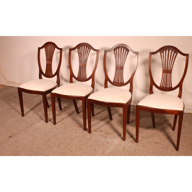 Exquisite set of four late 19th-century mahogany chairs with inlays. A truly beautiful set distinguished by its...