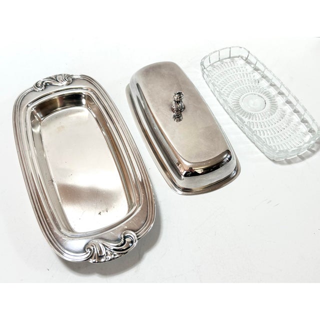 Made by the Rogers Silver Co., this elegant vintage covered butter dish features a streamlined silverplate base and lid...