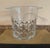 Elegant vintage cut glass ice bucket featuring a diamond pattern and small side handles. The clear glass catches the light...