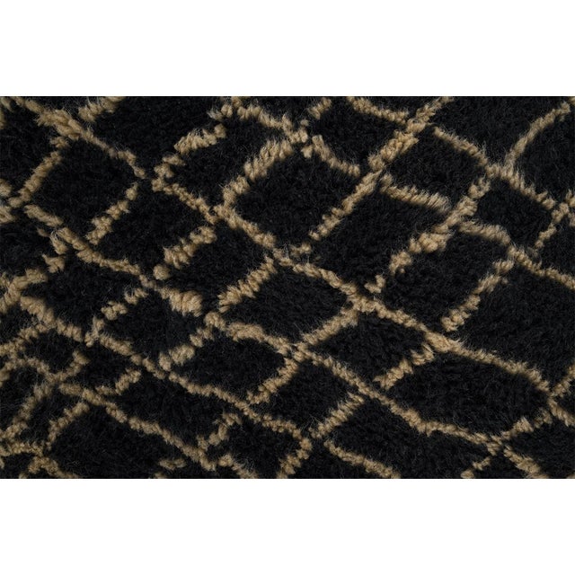 Darkness and light, woven into one extraordinary floor piece. This large-format hand-knotted Moroccan rug commands...