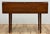Vintage handmade drop leaf table with four sturdy turned legs. One leaf to either side of center. Table measures 16.5"D...