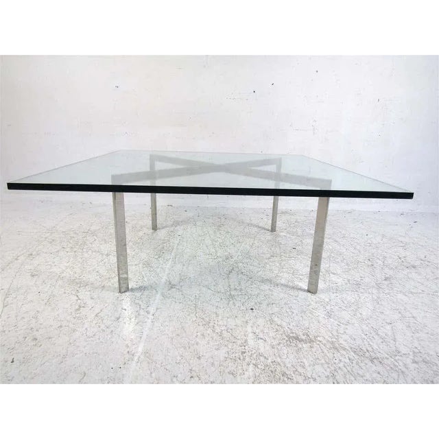 Stylish midcentury coffee or cocktail table. Chrome base, with a sizable piece of beveled glass serving as the tabletop....