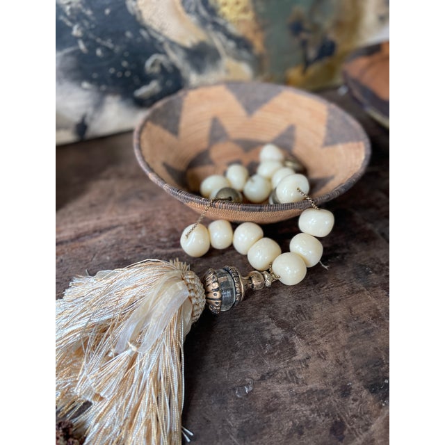 wonderful old native american basket, likely apache, presented in a tightly coiled and woven pattern of natural colors....