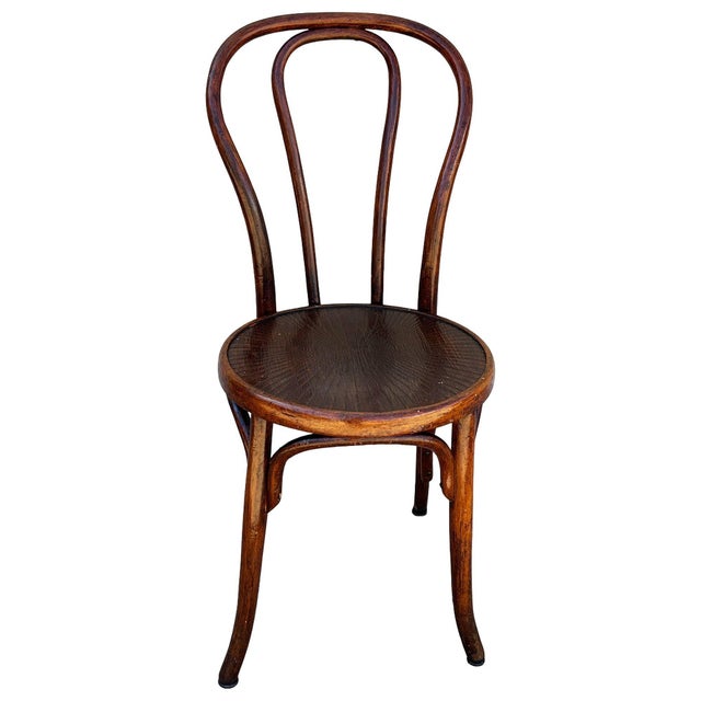 The Victorian Bistro side chair features an elegant, sculptural frame crafted from warm-toned bentwood with striking,...