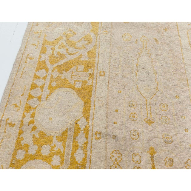 An early 20th century Indian Amritsar antique carpet, the cream field with a delicate overall pattern of palmettes,...