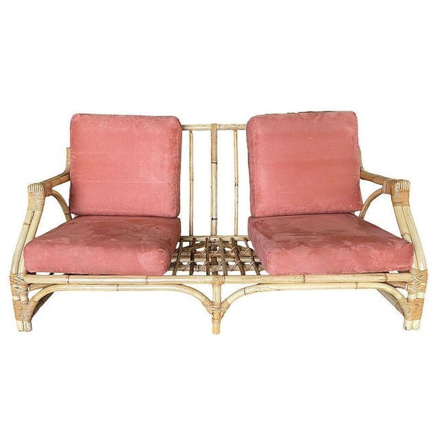 Mid-century two-strand transitional arm 3 seat sofa with arched base. This sofa features a unique pole rattan back with...